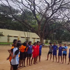 Our girls team listening to instructions before a practice match. Team huddles like this build unity and ensure everyone is on the same page.