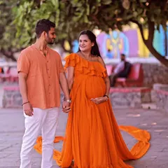 Our mustard georgette gown features four separate trails for a unique, wing-like effect. It's a vibrant and dynamic choice for a memorable maternity or pre-wedding shoot.