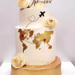 This "Forever Adventure" cake was for a couple's wedding, celebrating their love story that spans across the globe. The edible gold world map is a beautiful, personal touch.