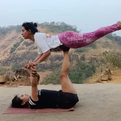 Anytime, anywhere, yoga and only yoga. A fun Acro Yoga pose, front bird, against a beautiful mountain backdrop. It's all about strength, balance, and having fun.