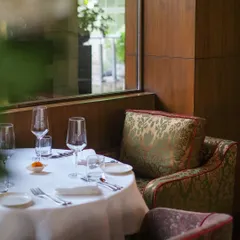 We believe that the setting is an essential part of the meal. This image captures a quiet corner of our dining room, with its plush seating and perfectly set table, ready to welcome guests for an unforgettable experience.