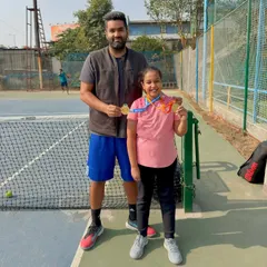 Pratyaksha Singhal showing her two medals from her school tennis tournament at Kothari International School, where she won both the Under-11 and Under-13 categories. We are very happy with her progress.
