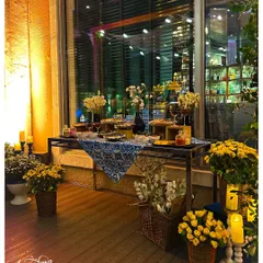 The appetizer and dessert table was styled with baskets of fresh flowers, glowing candles, and beautiful platters, all set against the warm glow of the city lights outside.