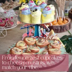 A whimsical dessert display for a baby shower, featuring colorful cupcakes and cinnamon rolls on a carousel stand. We love matching our sweet treats to your party's vibe, from lemon zest cupcakes to cheesy crostinis.