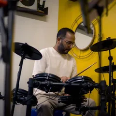 The focus and energy of a drummer during a live performance at our studio. These sessions are all about creating unforgettable musical memories.