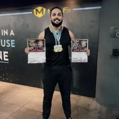 We train athletes who compete and win. Here is our member, Srinivas, proudly displaying his two gold medals and diplomas from the AWPC World Cup, right here in our gym.