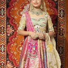 This multi-colored lehenga is a celebration in itself, featuring rich pinks, golds, and intricate patterns. Paired with our heavy kundan jewellery, it creates a complete and unforgettable bridal look.
