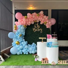 A modern and popular 'He or She' gender reveal party. I used a stylish grass wall backdrop with a pink and blue organic balloon garland to create the perfect photo opportunity for the happy couple.