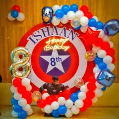An Avengers theme is always a hit, and this Captain America setup was for an 8th birthday. I used a custom backdrop of the iconic shield, a balloon garland in red, white, and blue, and the birthday boy's name integrated into the design.