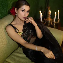 An elegant shot from my magazine feature, capturing a model in a black lace saree. The warm, candle-lit setting creates a romantic and timeless mood.