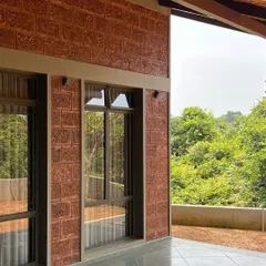 For this holiday home in Mangalore, we used locally sourced laterite stone for the walls. Its rich, earthy red color and porous texture give the building a strong sense of place and regional identity.