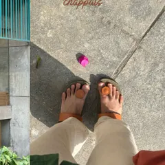 My sunbathing chappals, a quirky self-portrait of my feet on the pavement.