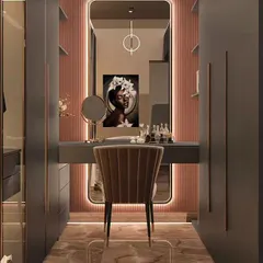 A dedicated walk-in dressing area I designed with a sleek vanity table. The space features backlit mirrors and ample closet space with both open and closed storage for a glamorous feel.