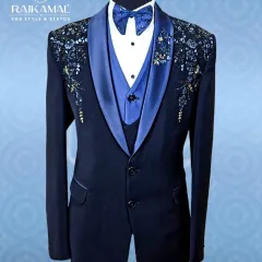 For a reception or cocktail evening, I designed this navy blue tuxedo to be a showstopper. It features a satin lapel and exquisite floral beadwork on the shoulders, offering a sharp, modern silhouette with a touch of regal flair.