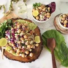 Our protein-packed chickpea salad is a favorite among clients. It's made with fresh chopped vegetables like cucumber, onions, and red cabbage, with a light dressing. It can be a part of your meal or a light lunch on its own.