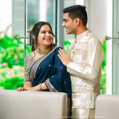 An engaged couple shares a sweet, candid moment during their indoor photoshoot. I use natural light from the large windows to create a soft, romantic feel for pre-wedding portraits.