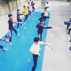 A high-angle view of an outdoor training session. You can see the entire class practicing their punches in unison, a testament to the discipline and focus I instill in every student.