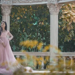 A fairytale moment in a beautiful garden gazebo set. The bride-to-be looks like a princess in her flowing pink gown.