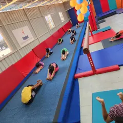 The gym was decorated with balloons for our first anniversary, but the real celebration was seeing our students stretching and training together.