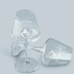 A minimalist shot of Bira 91 branded wine glasses against a solid light-grey background. This clean and simple presentation is ideal for showcasing merchandise on a brand's online store.