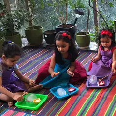 A magical birthday activity! These little princesses are engaged in an ice play activity, where they excavate small toys from frozen ice balls using droppers with warm water.