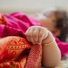 Details are my specialty. The tiny grip of a baby’s hand on a traditional silk cloth tells a story of its own, a memory of just how small they once were.