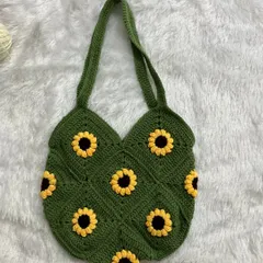 This is my sunflower granny square tote bag in a beautiful olive green. It's a spacious and eye-catching bag, perfect for carrying your daily essentials.