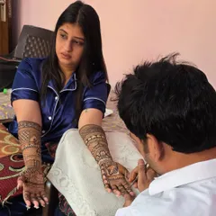 Here I am, focused on applying a detailed bridal mehandi. It takes hours of patience and concentration to ensure every line is perfect for the bride's special day.