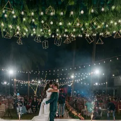 This is what a high-energy Sangeet night looks like. I combined a canopy of lush greenery with geometric lanterns and string lights to create a magical, open-air dance floor where the couple could celebrate under the stars.