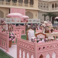 The 'Pink Jaipuri Bagh' mehendi featured distinct seating areas enclosed by custom-made pink jali fences, creating intimate and picturesque spaces.