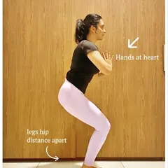 If holding your arms up in Chair Pose feels like too much, this modification with hands at the heart is a great option. It allows you to focus on strengthening your legs and core without straining your shoulders.