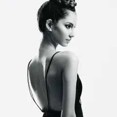 A study in elegance. This black and white portrait highlights a beautifully intricate braided updo and the graceful line of the model's back. The makeup is soft and clean to enhance her natural features.
