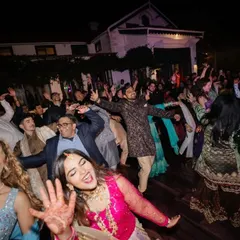 The energy of a great party is contagious. We create the perfect environment for guests to celebrate, as seen here on a packed dance floor during a lively Sangeet night.