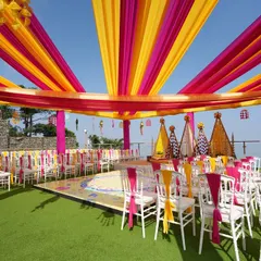A wide view of the entire seaside Haldi setup, showing the stage, guest seating, and the stunning ocean view. We ensure every element comes together for a cohesive and beautiful event.