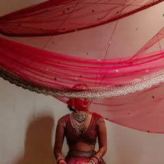 An artistic portrait using the bride's dupatta to create a sense of mystery and elegance. This creative approach results in truly one-of-a-kind bridal photos.