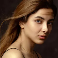This is where simplicity meets soul. A classic studio headshot where the focus is entirely on the subject's expressive eyes and serene confidence, captured with soft, cinematic lighting.
