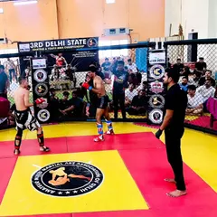 Two fighters squaring off at the 3rd Delhi State MMA Championship. This is the moment before the bell rings, a test of focus and strategy.