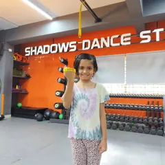 Saisha proudly displays her new yellow band. A brilliant performance in the intermediate level test earned her this achievement.