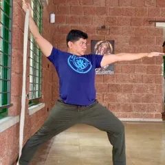 Props are a great way to support your self-practice. Here, a strap is used against the wall to find correct alignment and deepen the stretch in Virabhadrasana II (Warrior II).