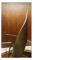 The handrail of this spiral staircase is a single, sculptural piece of aged brass. It was crafted to fit the hand, the space, and the proportions perfectly, turning a functional element into a work of art.