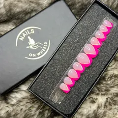 A vibrant twist on the classic French manicure. This set features a sheer base with bold, hot pink V-shaped tips, perfect for anyone who loves bright colors and modern nail designs.