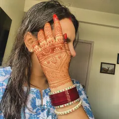 A client showing off the gorgeous, deep orange stain of her Karvachauth mehndi. This is the beautiful color you can expect as the henna matures.