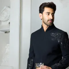 For the man who seeks the extraordinary, this black bandhgala features a hand-embroidered cheetah motif across the shoulder. It is a testament to exquisite Indian craftsmanship, symbolizing grace and power for life's unforgettable moments.