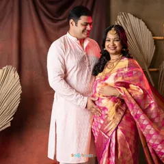 This couple is glowing with happiness. Her magnificent pink and gold silk saree looks so regal in our studio. It’s a perfect way to celebrate this special time with traditional elegance.