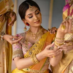 A beautiful candid moment of a bride getting ready, with her bridesmaids helping her with her jewelry. This shot captures the intimacy and excitement of the pre-ceremony moments.