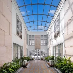 A key feature of The Grand Alabaster is this magnificent interior courtyard covered by a vast glass skylight. This architectural element floods the core of the home with natural light, creating a bright, airy atrium that feels like an open-air garden within the house.