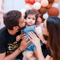 A beautiful color portrait of a family celebrating their daughter's first birthday. We capture the love and pride in the parents' eyes.