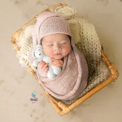Snuggled up with a tiny teddy bear, this little one is perfectly content. I use soft wraps and props like this to ensure the baby is comfortable and secure throughout the newborn session.