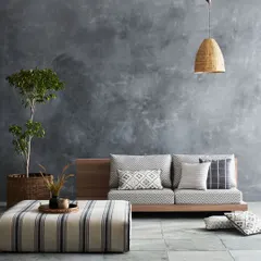 A minimalist living room scene with a focus on patterned upholstery. The neutral background and simple styling allow the fabric's design to be the main subject.