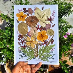 This piece is a bouquet of memories, made from real pressed flowers and leaves I've collected from my travels. It's a unique way to bring the beauty of nature indoors, preserving it forever in a delicate arrangement.